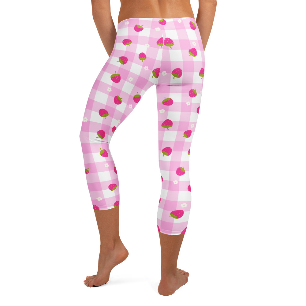Mid-calf capri leggings featuring pink gingham pattern with small strawberry motifs in cute ditsy style design