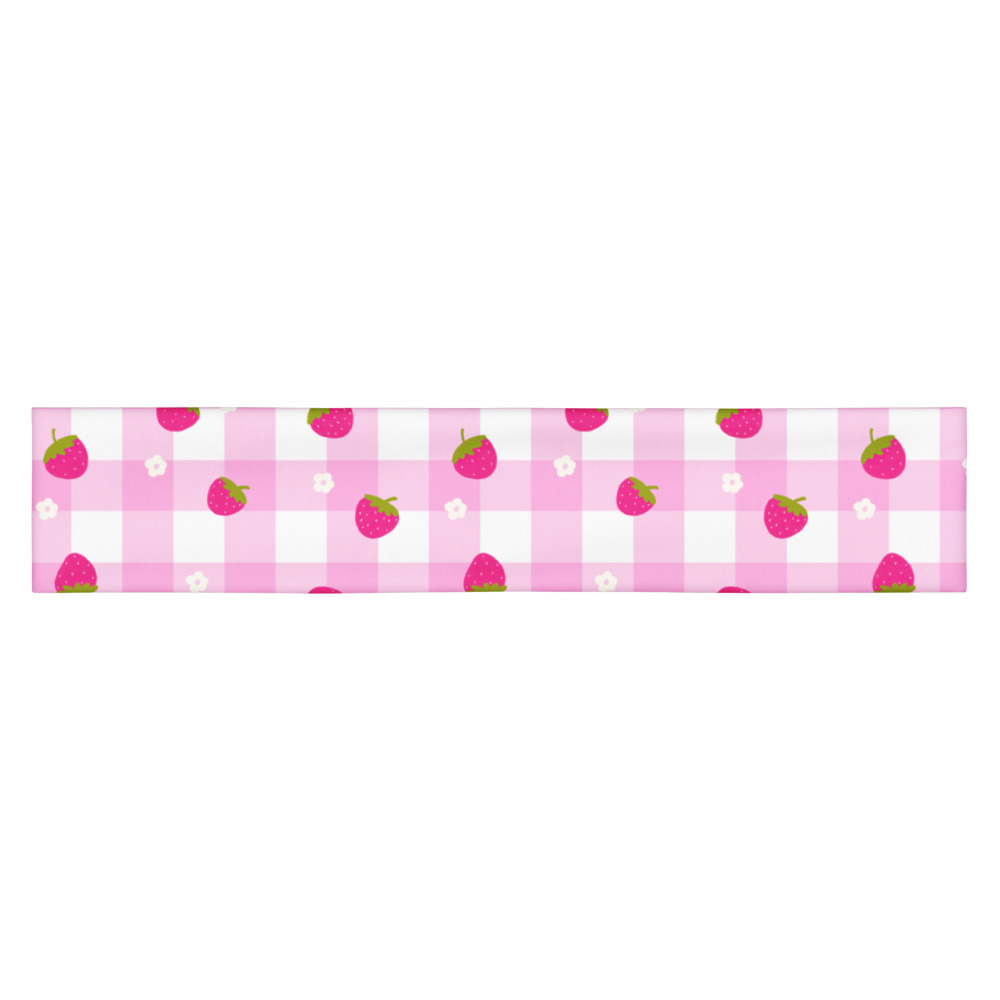 Pink gingham headband with small strawberry pattern scattered across checkered background in cute countryside style