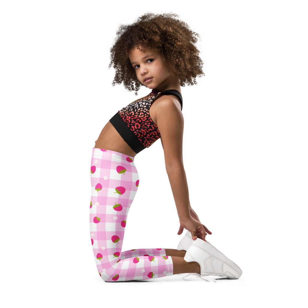 Kids leggings with pink gingham background and scattered strawberry ditsy pattern in cute vintage style