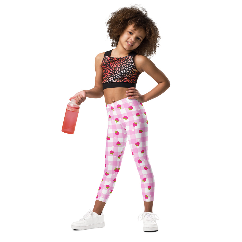 Kids leggings with pink gingham background and scattered strawberry ditsy pattern in cute vintage style