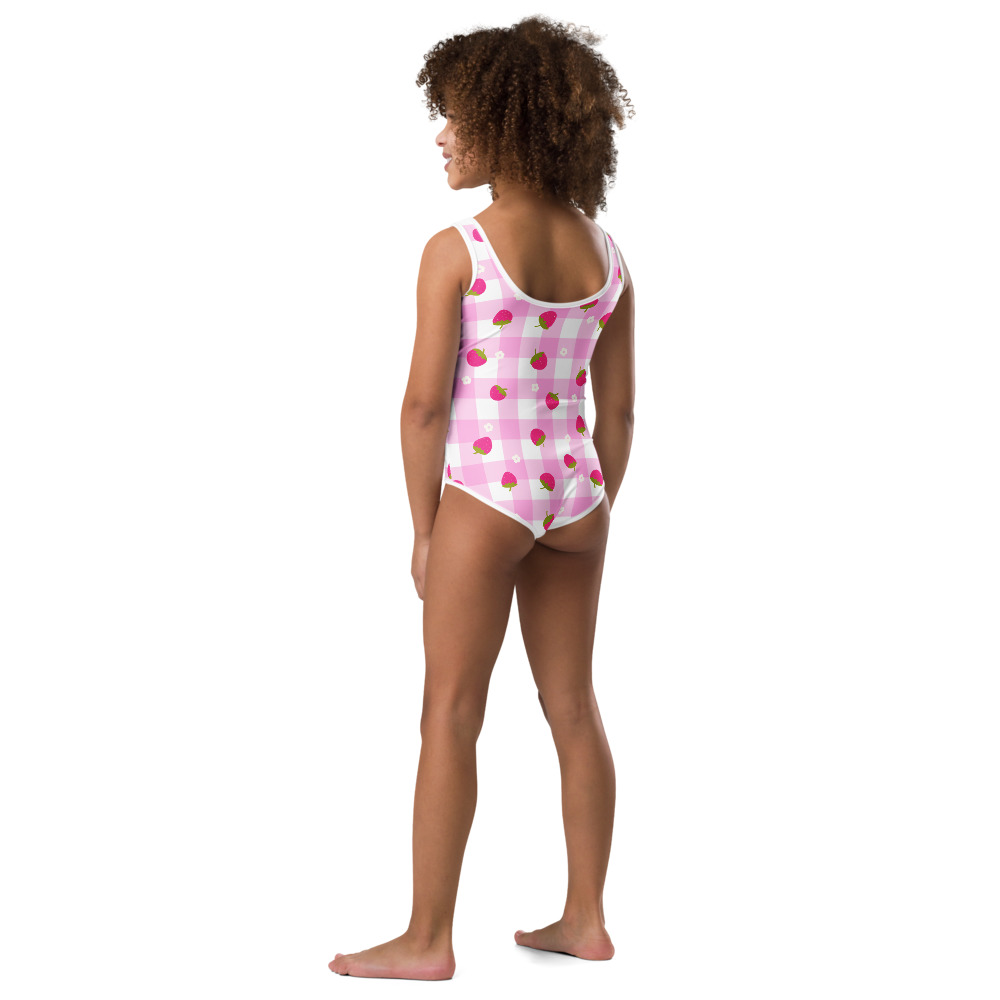 Kids swimsuit featuring pink gingham pattern with small strawberry ditsy print design in cute checkered style