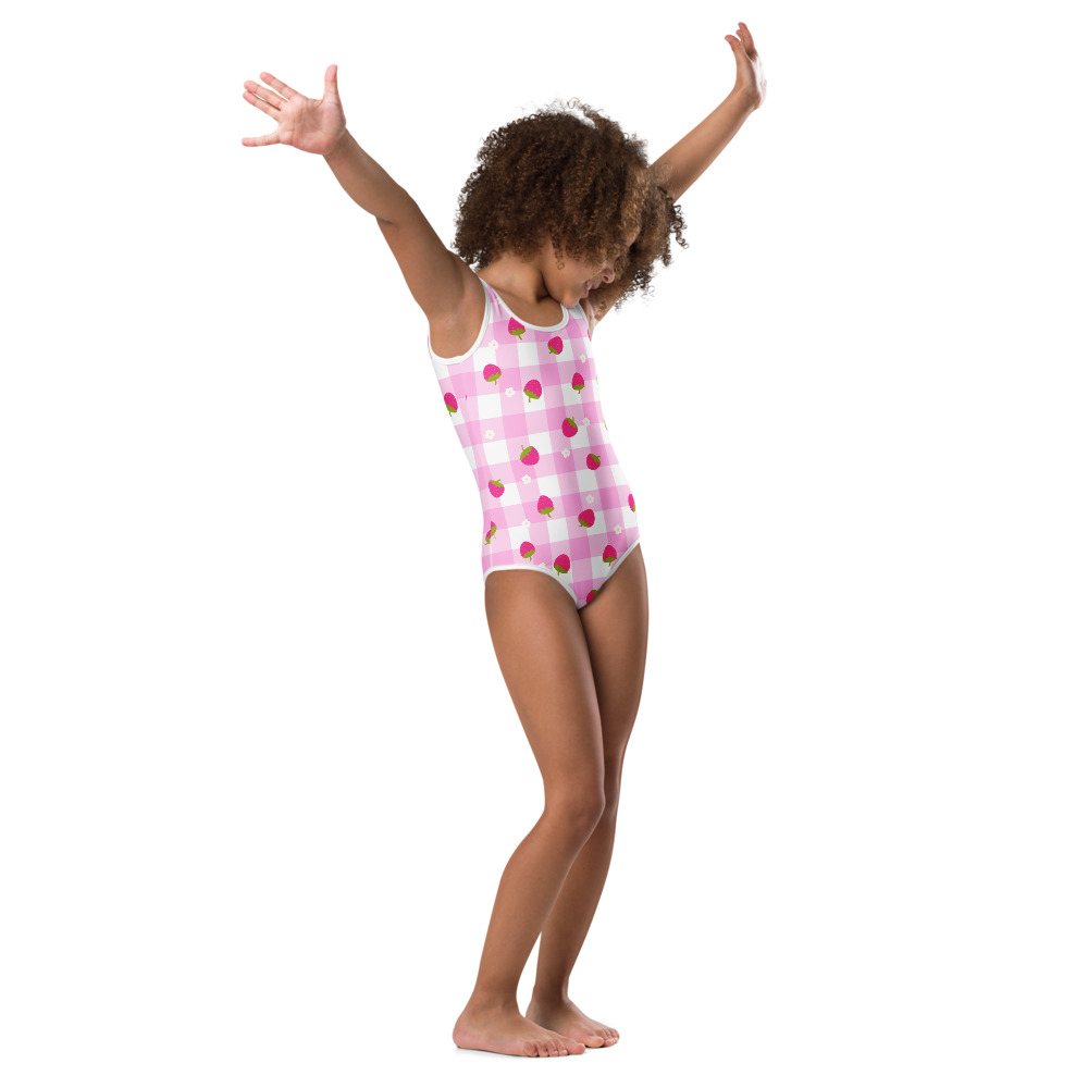 Kids swimsuit featuring pink gingham pattern with small strawberry ditsy print design in cute checkered style