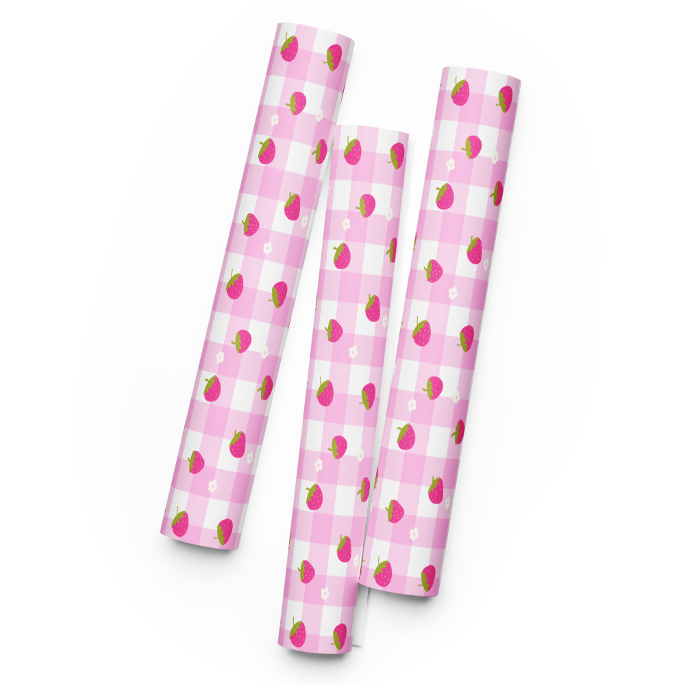 Pink and white gingham wrapping paper sheets with small strawberry pattern scattered across checkered background