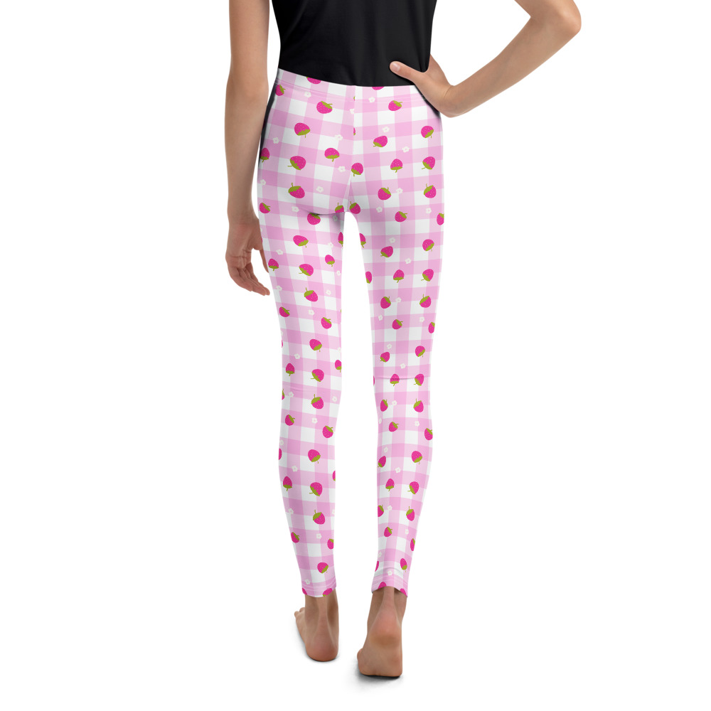 Youth leggings with pink gingham pattern featuring small strawberry design scattered across fabric