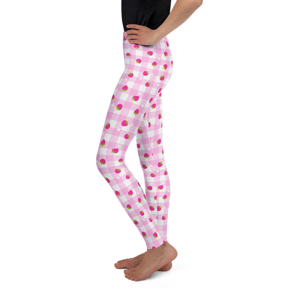 Youth leggings with pink gingham pattern featuring small strawberry design scattered across fabric