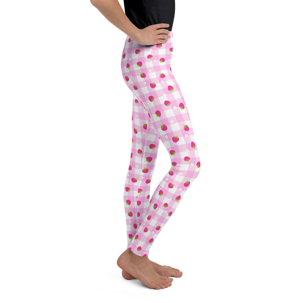 Youth leggings with pink gingham pattern featuring small strawberry design scattered across fabric